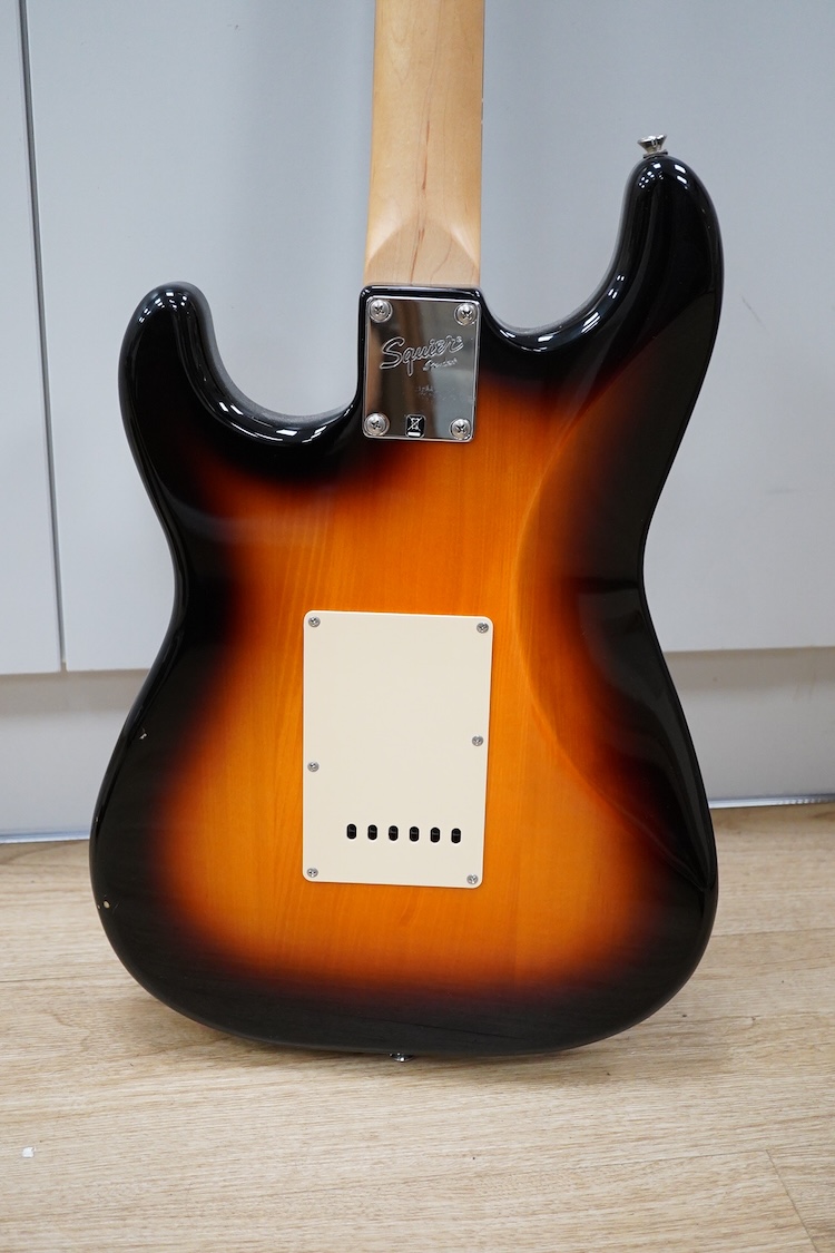 A Fender Squire electric guitar, with a Kinsman soft case, together with a Peavey VYPYR 15W modelling amplifier